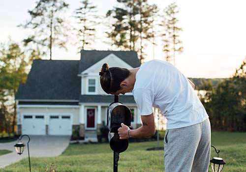 Homeowner checks empty mailbox