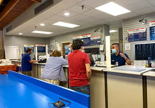 People mailing packages at a post office