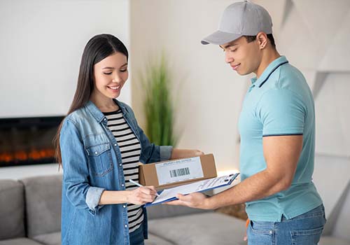 Young female signing delivery documents