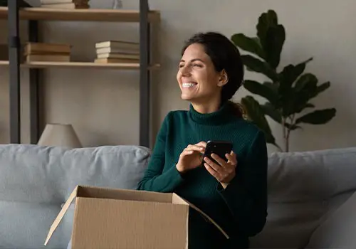 A smiling woman next to an open box.